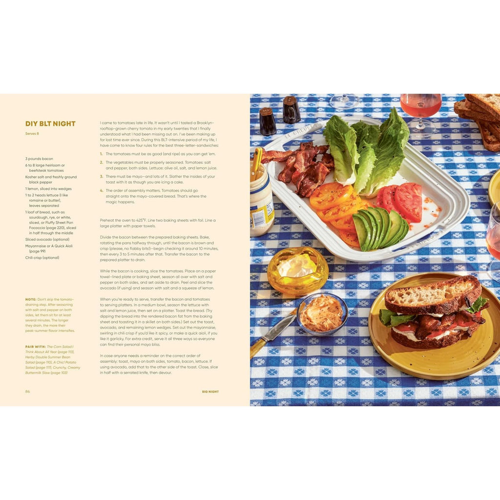 A cookbook page from "Big Night: Dinners, Parties, and Dinner Parties" by Gneiss Spice showcases a recipe on the left. On the right side, a vibrant food spread suitable for dinner parties is set upon a blue checkered tablecloth featuring sliced tomatoes, crispy bacon, fresh lettuce, creamy avocado, a prepared sandwich, and refreshing drinks—exemplifying home entertaining at its finest.