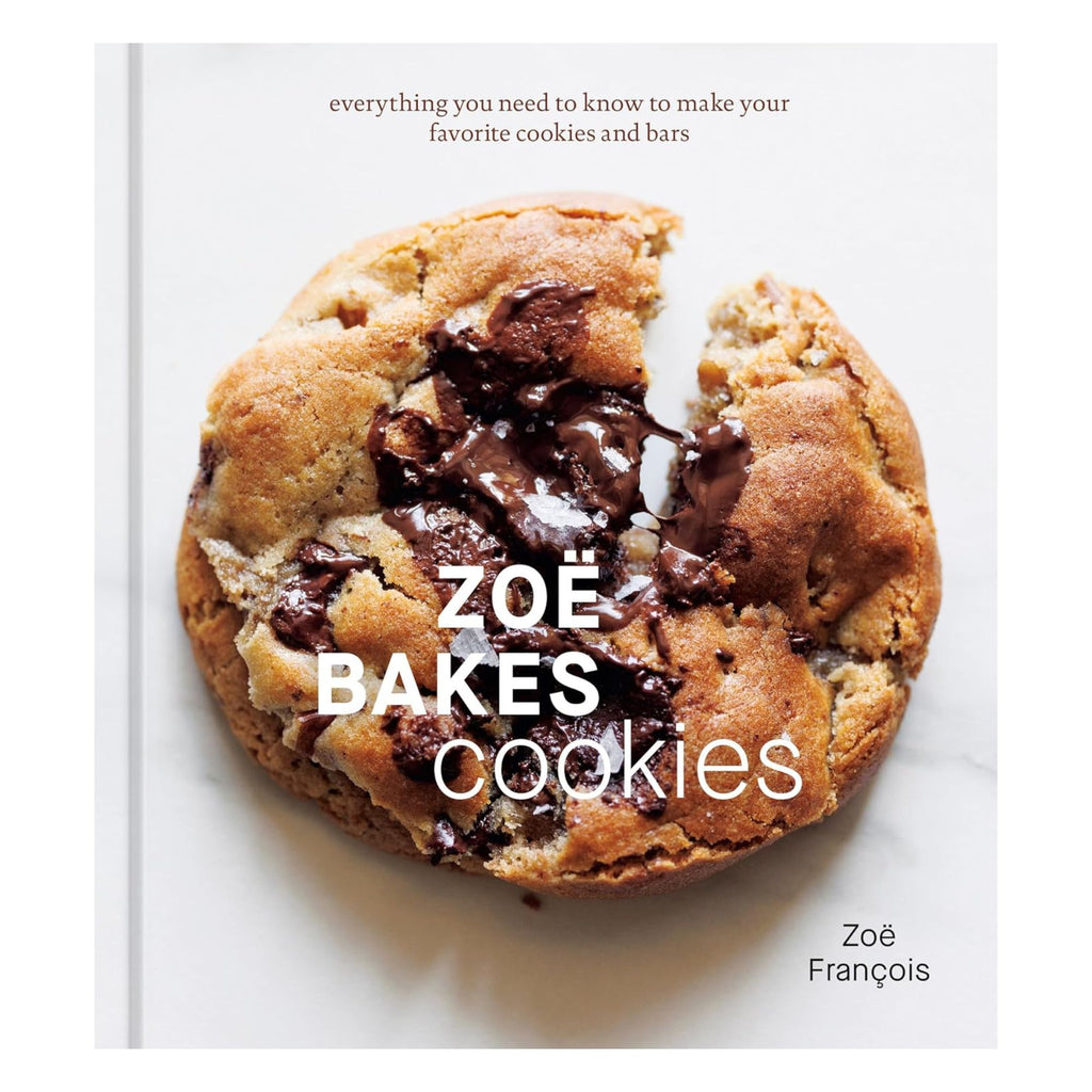 A close-up of the cookbook cover titled "Zoë Bakes Cookies: Everything You Need to Know to Make Your Favorite Cookies and Bars" by Zoë François from Gneiss Spice showcases a freshly baked chocolate chip cookie with melty chocolate pieces, ideal for cookie recipe enthusiasts. The background features a plain white surface.