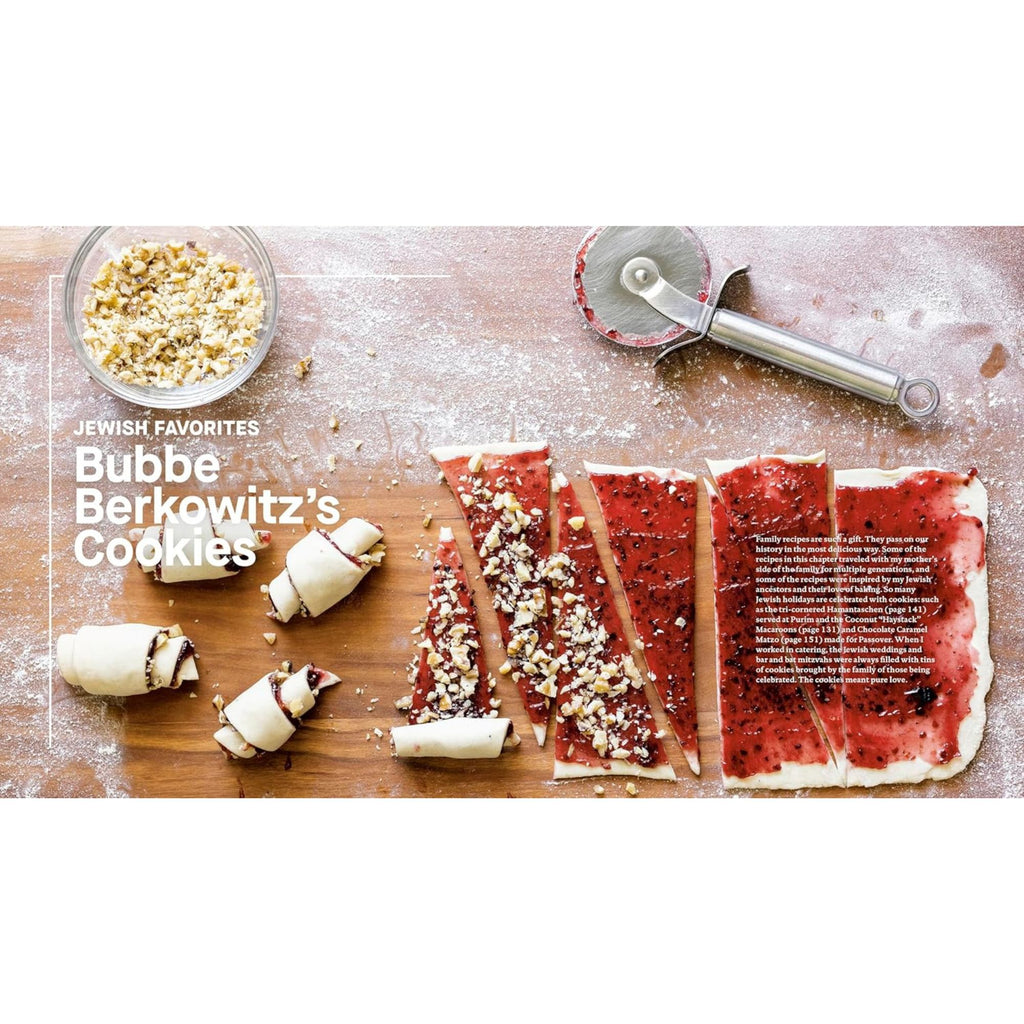 On a wooden board, triangular pieces of dough shimmer with red jam and crushed nuts, some expertly rolled into cookies. A pizza cutter rests nearby, while a bowl of nuts lingers in the background. Text reads "Jewish Favorites: Bubbe Berkowitz's Cookies." Inspired by Zoë Bakes Cookies: Everything You Need to Know to Make Your Favorite Cookies and Bars from Gneiss Spice.