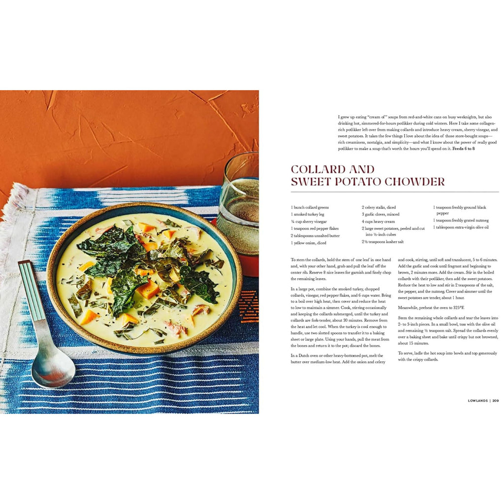 A bowl of creamy collard and sweet potato chowder, reflective of Southern cuisine, is placed on a blue placemat with a spoon next to it. Visible chunks of collard greens and sweet potatoes add to the dish's appeal. In the background, there’s a glass of drink along with a page from "Our South: Black Food Through My Lens" by Gneiss Spice, highlighting the richness of Black foodways.