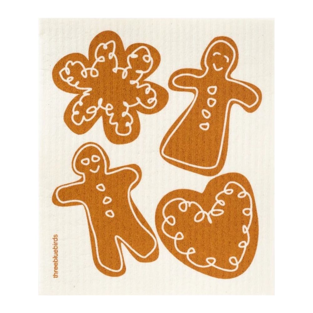 Four gingerbread cookies, shaped like a snowflake, a person with a dress, a person, and a heart, are adorned with elegant swirly white icing against a cream backdrop. This design captures the delightful style characteristic of Gneiss Spice's Swedish Dishcloth Holiday Promotion — Buy 3, Get 1 Free.