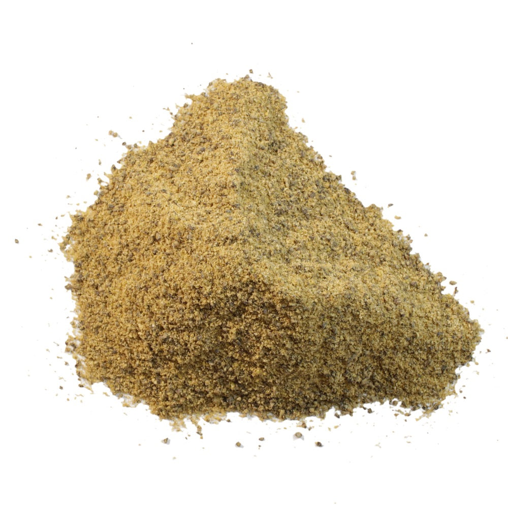 A pile of finely ground brownish-yellow flour is arranged in a pyramid shape against a plain white background, reminiscent of Gneiss Spice's Green Chili (Medium) Chili Powder. The texture appears coarse and grainy.