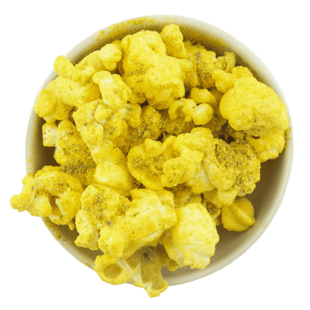 A bowl of golden yellow popcorn, coated with Gneiss Spice's Mac-n-Cheese seasoning, sits on a plain background. This fluffy treat is generously dusted with savory spices and is an eco-friendly snack option due to its zero-waste spice refills.