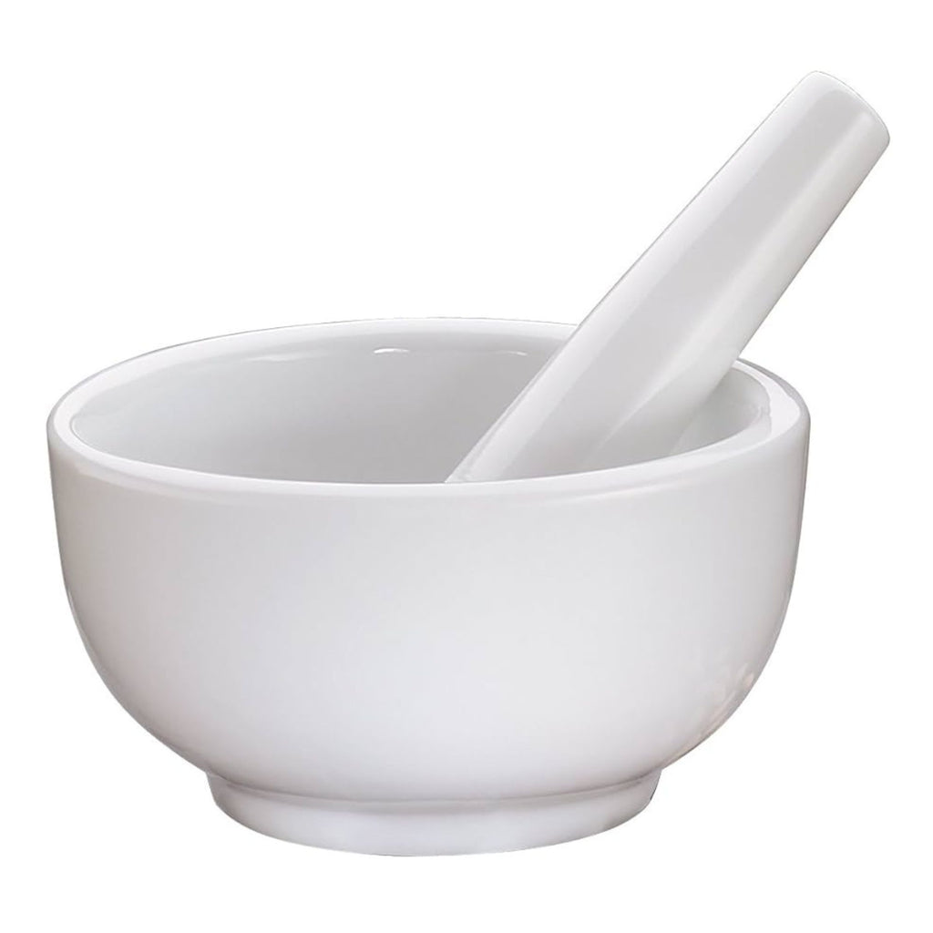 Crafted from porcelain, the Gneiss Spice Mortar & Pestle — Medium 3.5" is an ideal kitchen tool for grinding spices. The pestle fits neatly within the pristine white ceramic mortar, set against a simple white background.