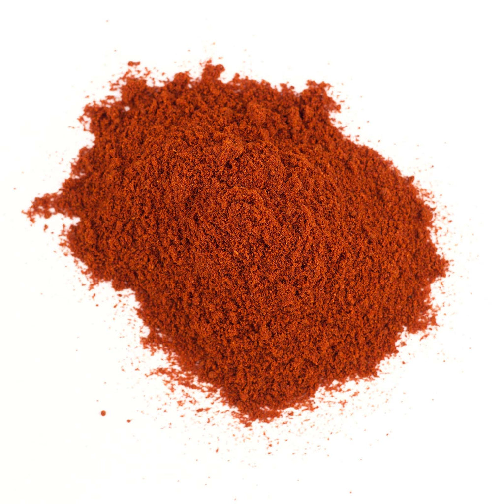 A pile of Gneiss Spice's Paprika (Smoked) on a white background. This fine powder showcases a rich, vibrant red color, which reflects its potent flavor, making it a popular choice in cooking for seasoning and adding a smoky, sweet, or spicy taste to dishes.