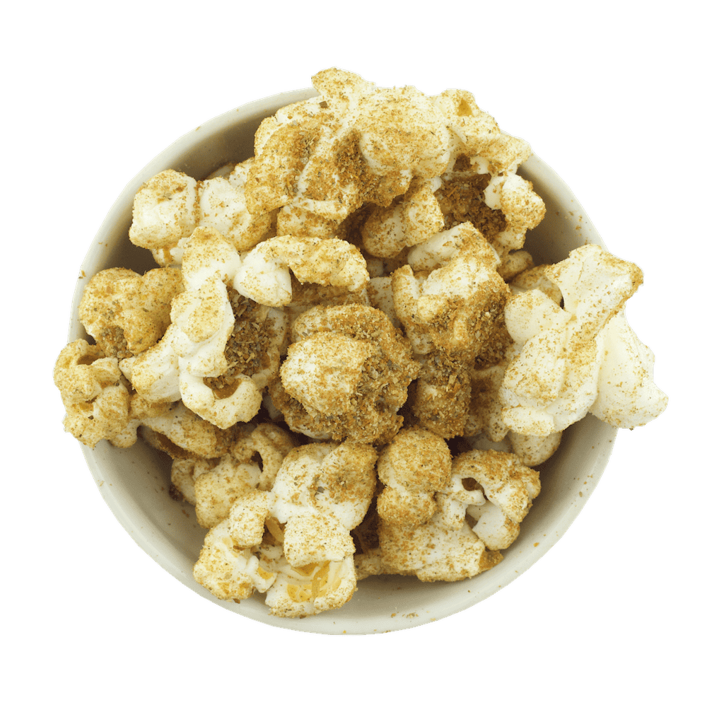 A top view of Gneiss Spice's "Comfort Foods" Popcorn in Mac & Cheese flavor, sprinkled with a rich blend of yellow and brown organic seasonings.