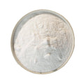 Fine white vinegar powder in a round dish, seen from above