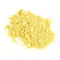 A small pile of Gneiss Spice’s Mustard Seed Yellow (Powder) Organic is scattered on a white background, its vibrant yellow color highlighting the freshness of this zero-waste spice refill.